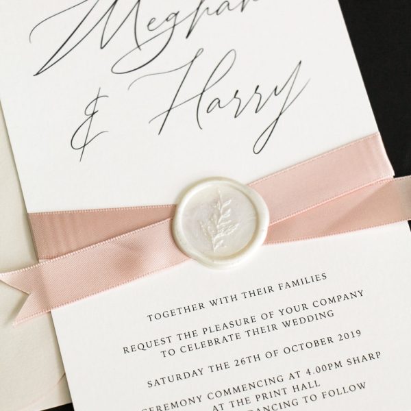 Sealed satin wedding invitation with satin ribbon and wax seal