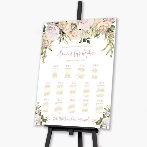 lush roses blush wedding seating plan on black easel