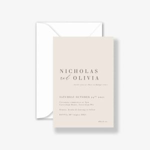 Textured vanilla wedding invitation on almond card with classic white envelope