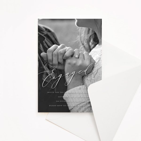 Engagement invitation with close up photo of couple's hands holding