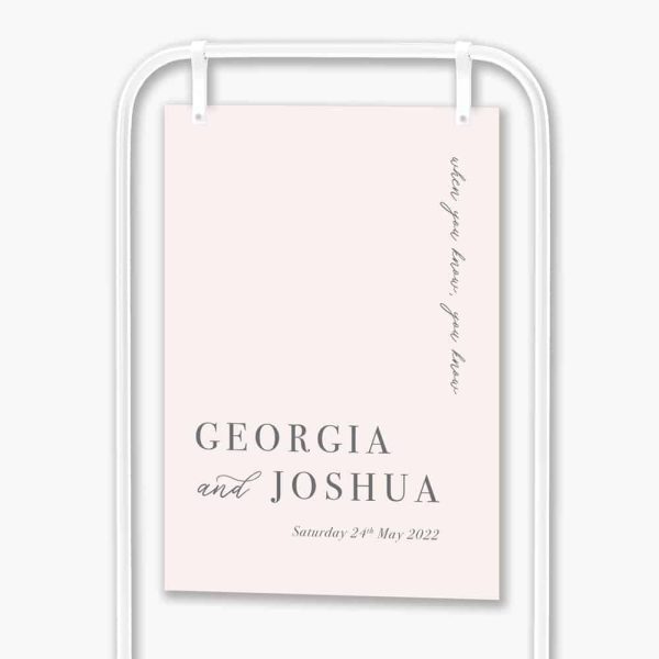 Soft pink welcome sign hanging in white frame