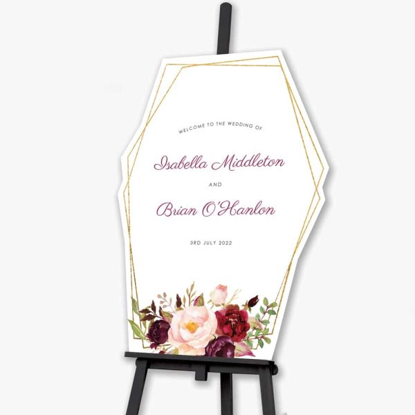 geometric marsala welcome sign sitting on black easel