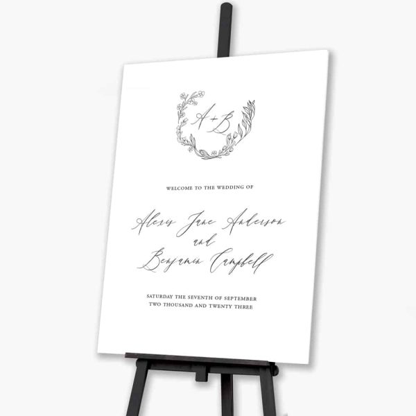 soft silk wreath welcome sign sitting on easel