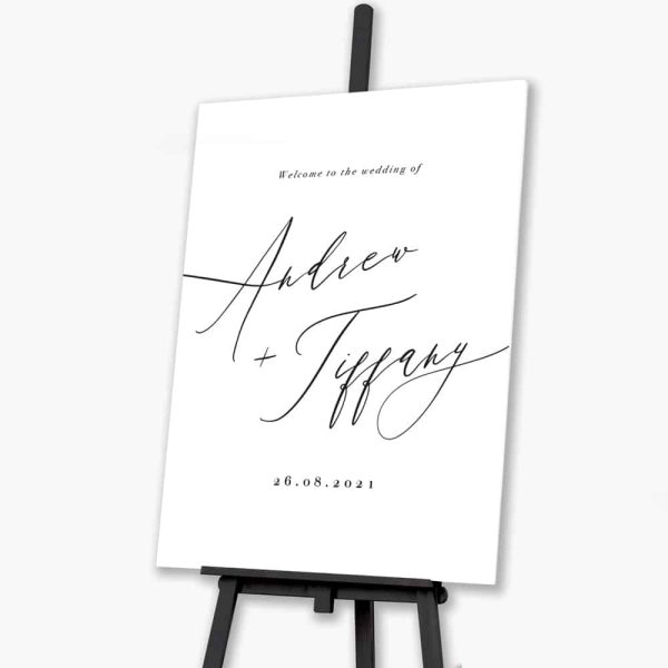 timeless script welcome sign sitting on black easel