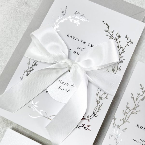 Delicate Wreath with silver foil and white satin bow wedding invitation