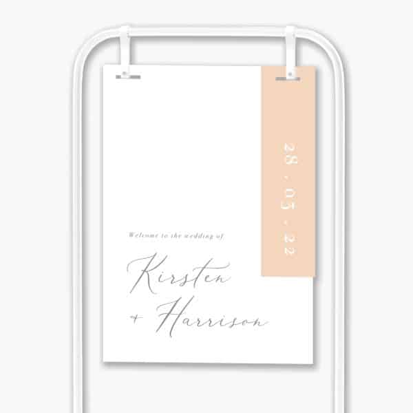 delicate blush welcome sign hanging in white frame