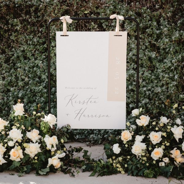 delicate blush welcome sign with flowers