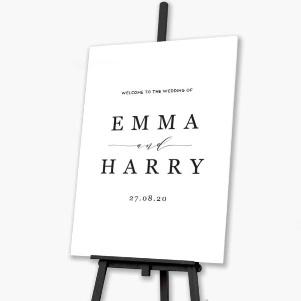 Grey stone welcome sign sitting on black easel
