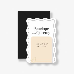Wedding Invitation with wave shape and minimalist black text with black border. Sand coloured details card, gold paperclip, and black envelope