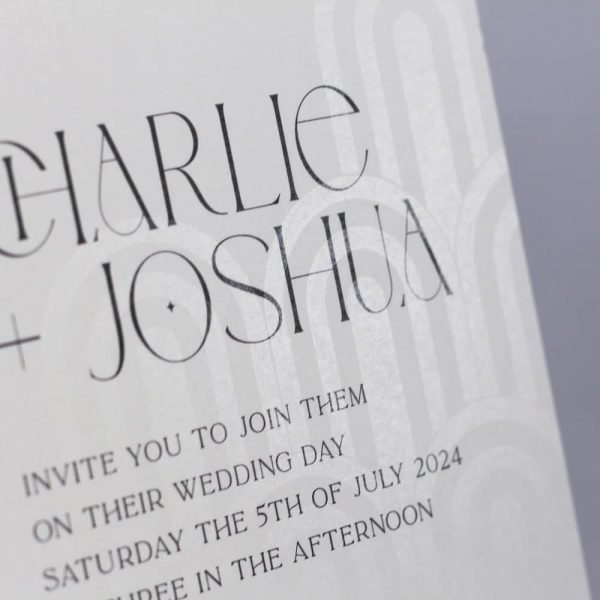 Art deco affair wedding invitation suite. Cream invitation with art deco shapes printed in clear ink