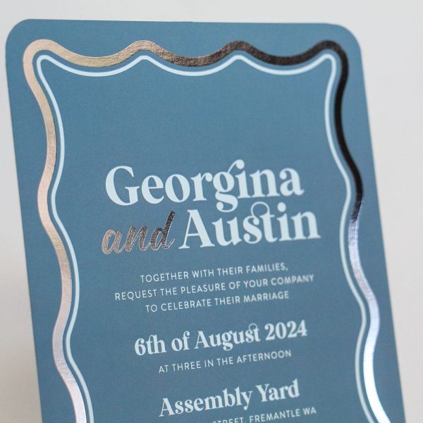 Electric Sky Wedding Invitation with blue background, silver foiled wave border and light sky blue details card