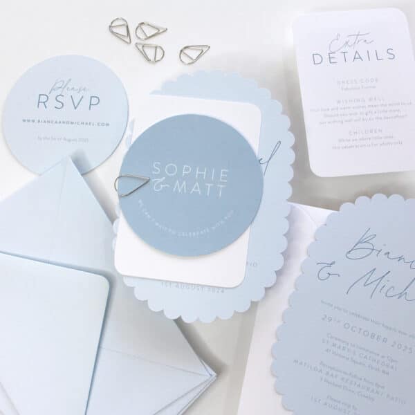 scalloped sky wedding invitation shown layered