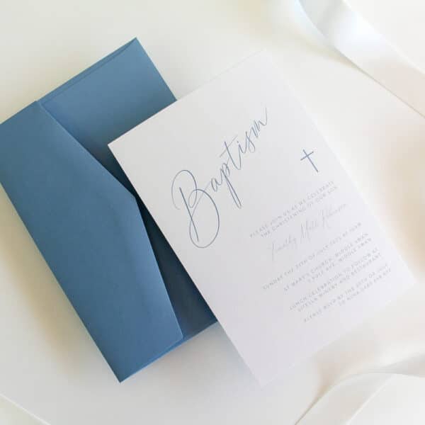 A baptism invitation with simple cursive writing and envelope
